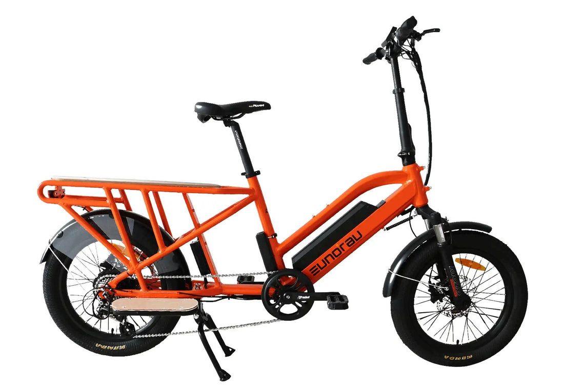 Orange electric bike with black frame on a white background.