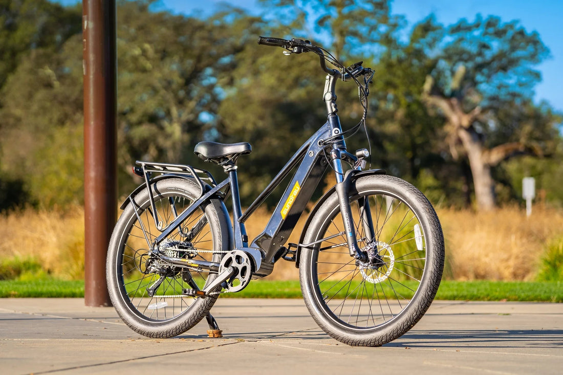 Electric bicycle on a paved path with trees in the background.