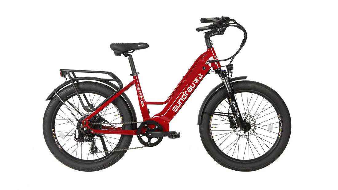 Profile view of a glossy cherry red Eunorau META24 1.0 step-through electric bicycle against a solid white background, featuring a front suspension fork, integrated rear cargo rack, 24-inch wheels with wide tires, and a rear hub motor.